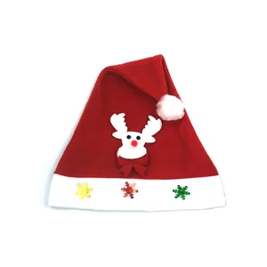 Detail of cartoon reindeer and colorful snowflake sequins on red velvet Christmas hat