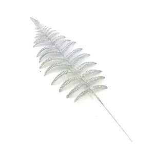 Detailed view of artificial silver glitter fern leaf for elegant Christmas tree decor