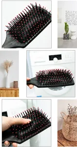 Black paddle hair brush with red-tipped pins for gentle scalp massage and anti-tangle care.