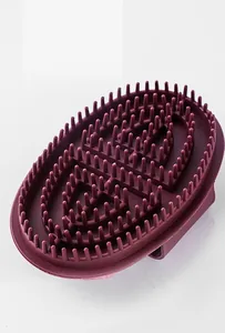 Silicone meridian massage brush detail showing the dense ergonomic spikes and oval grip handle.
