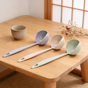 Detailed view of wheat straw soup colander spoons in multi colors set on wooden table.