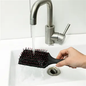 Black cushion paddle hair brush with massaging ball-tipped bristles for detangling wet hair.