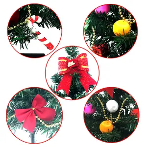 Detailed view of assorted Christmas tree ornaments including red bows and baubles