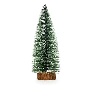 Detailed view of mini green cedar Christmas tree with snow effect on a wooden base