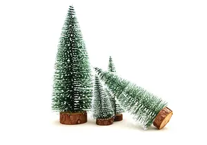 Group of mini cedar Christmas trees with snow-tipped needles and rustic wood bases
