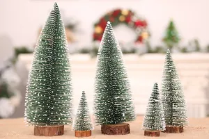 Five mini snow-flocked cedar Christmas trees in various sizes on rustic wood bases.