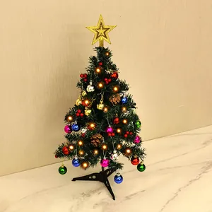Mini tabletop Christmas tree set decorated with colorful ornaments and warm LED lights
