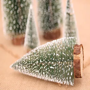 Macro view of mini cedar Christmas tree ornament with snow and rustic wood base
