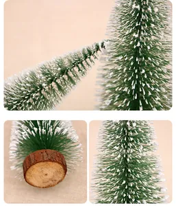 Macro view of mini cedar Christmas tree with snow tips and natural wood base.