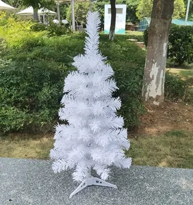 Detailed view of a small white artificial Christmas tree for tabletop festive decoration