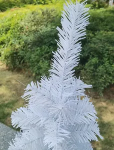 Detailed close-up view showing the dense white needles of this small artificial Christmas tree.