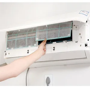 Detail view showing the installation of air conditioner dust filter mesh for clean air.