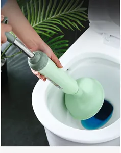 Detail view of green toilet plunger with stainless steel rod for clearing bathroom clogs.