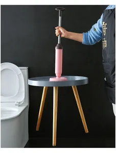 Detail view of a pink manual toilet plunger with stainless steel rod and suction cup.