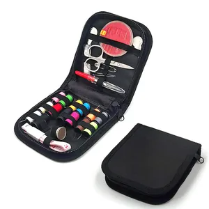 Portable sewing kit detail, black zipper case with threads, needles and essential tools for home.
