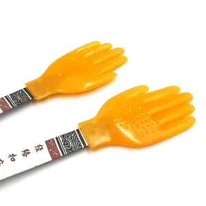 Silicone patting slap detail showing the flexible hand shaped massage head and patterned handle.
