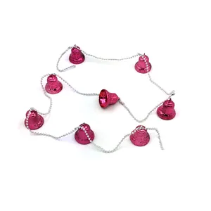 Detail view of pink metallic Christmas bell garland with silver bead chain connector