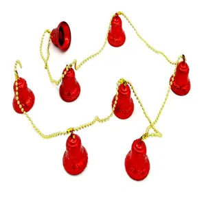 Macro view of festive red Christmas bells garland strung on a gold bead chain