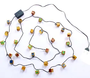 Detailed view of colorful Christmas string lights with heart-shaped cube lanterns.