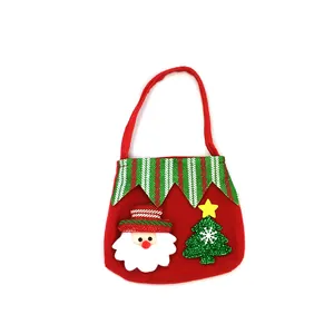 Close-up of a festive red felt Christmas gift bag featuring a Santa Claus and tree design.