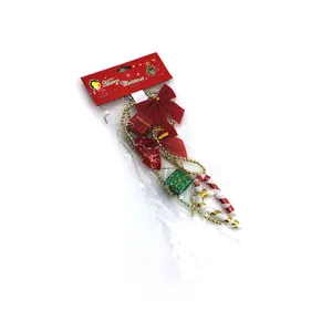 Christmas tree ornament set with red bows, gift boxes, and gold bead chain in packaging