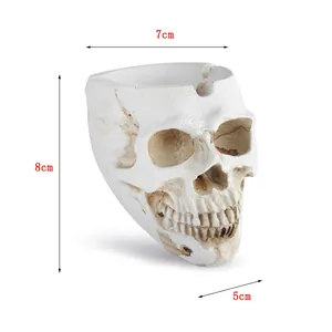 Detail view of the resin skull ashtray with dimensions 8cm height and 7cm width.
