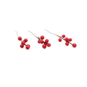 Close-up of artificial red glossy berries for Christmas DIY crafts and tree ornaments