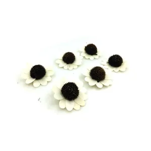 Detailed macro view of six white wooden sunflower heads for DIY handmade Christmas crafts.