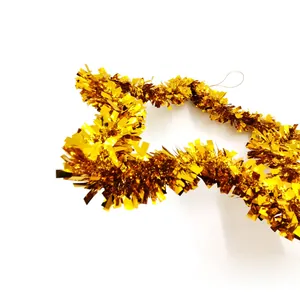 Close-up of shiny golden star tinsel garland for festive DIY Christmas decoration