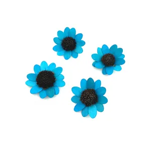 Detailed top view of four bright blue wooden sunflower craft accessories for DIY decor