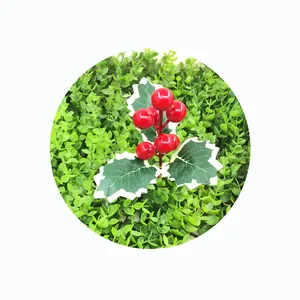 Close-up detail of artificial red holly berries with variegated green leaves for Christmas