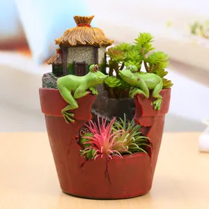 Creative resin flower pot featuring whimsical green frogs and a miniature cottage house.