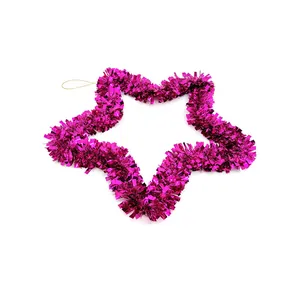 Detailed view of fuchsia pink tinsel star-shaped Christmas wreath hanging ornament