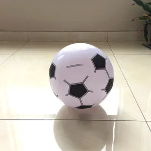 Detailed view of an inflatable beach ball with a classic soccer pattern on floor