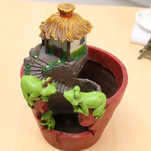 Detailed view of pastoral resin flower pot with miniature frogs and cottage design