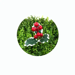 Detail view of artificial red holly berries with variegated green leaves for DIY decor