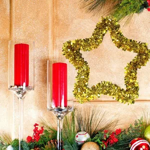 Detail view of 33cm gold tinsel star Christmas decoration in festive mantel setting