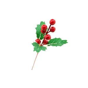 Detailed macro shot of artificial red holly berries and green leaves for Christmas DIY