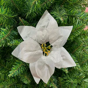 Close-up detail of a silver artificial poinsettia flower on Christmas tree branches