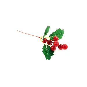 Close-up of artificial red Christmas berries with green leaves for DIY decor