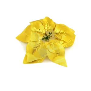 Macro view showing the intricate texture of a golden artificial poinsettia flower