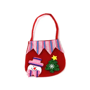 Detailed view of red Christmas gift bag featuring cute snowman and glittery tree patches