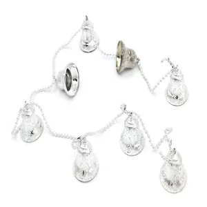 Detail shot of silver Christmas bell string with decorative textured finish and chain