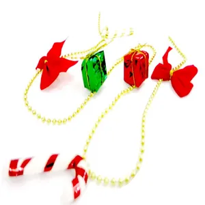 Detail view of festive Christmas tree beaded chain with bows and mini gift boxes