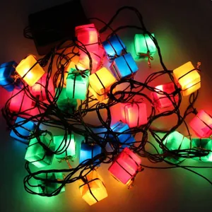 Detail showing glow of colorful Christmas gift box LED string lights for festive decor