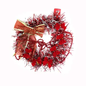 Festive Christmas wreath with red and silver tinsel, red bows, and gold striped ribbon