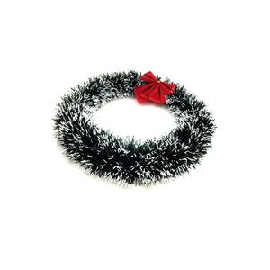 Close-up of 30cm green tinsel Christmas wreath decorated with a vibrant red bow