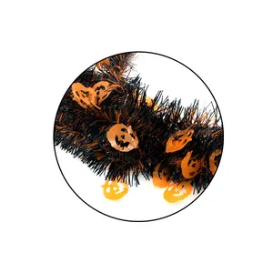 Detailed macro shot of black and orange Halloween tinsel garland with pumpkin motifs
