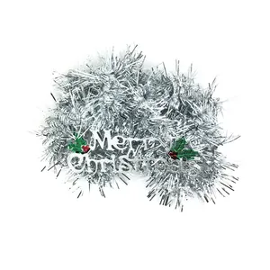 Macro view of silver Christmas tinsel garland with Merry Christmas sign
