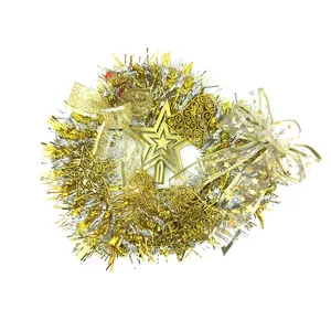 Assortment of festive Christmas tree ornaments with golden bells stars and tinsel